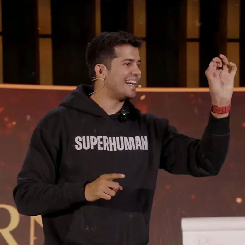 Swastik Nandakumar on stage in a Superhuman hoodie