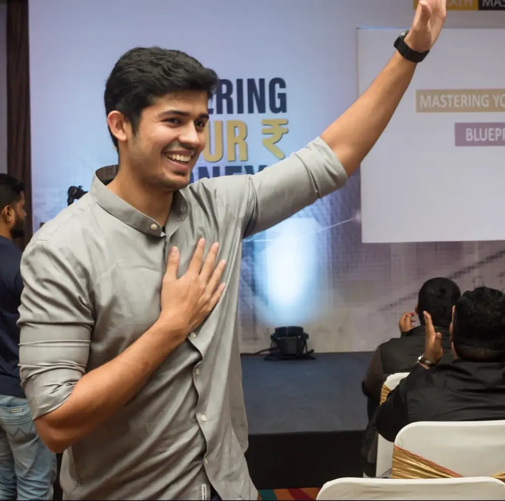 Swastik Nandakumar waving to the audience at a Mastering Your Money event