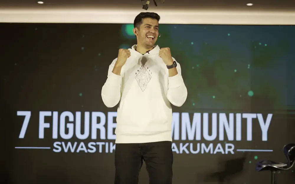 Swastik Nandakumar on stage at the 7 Figure Community event