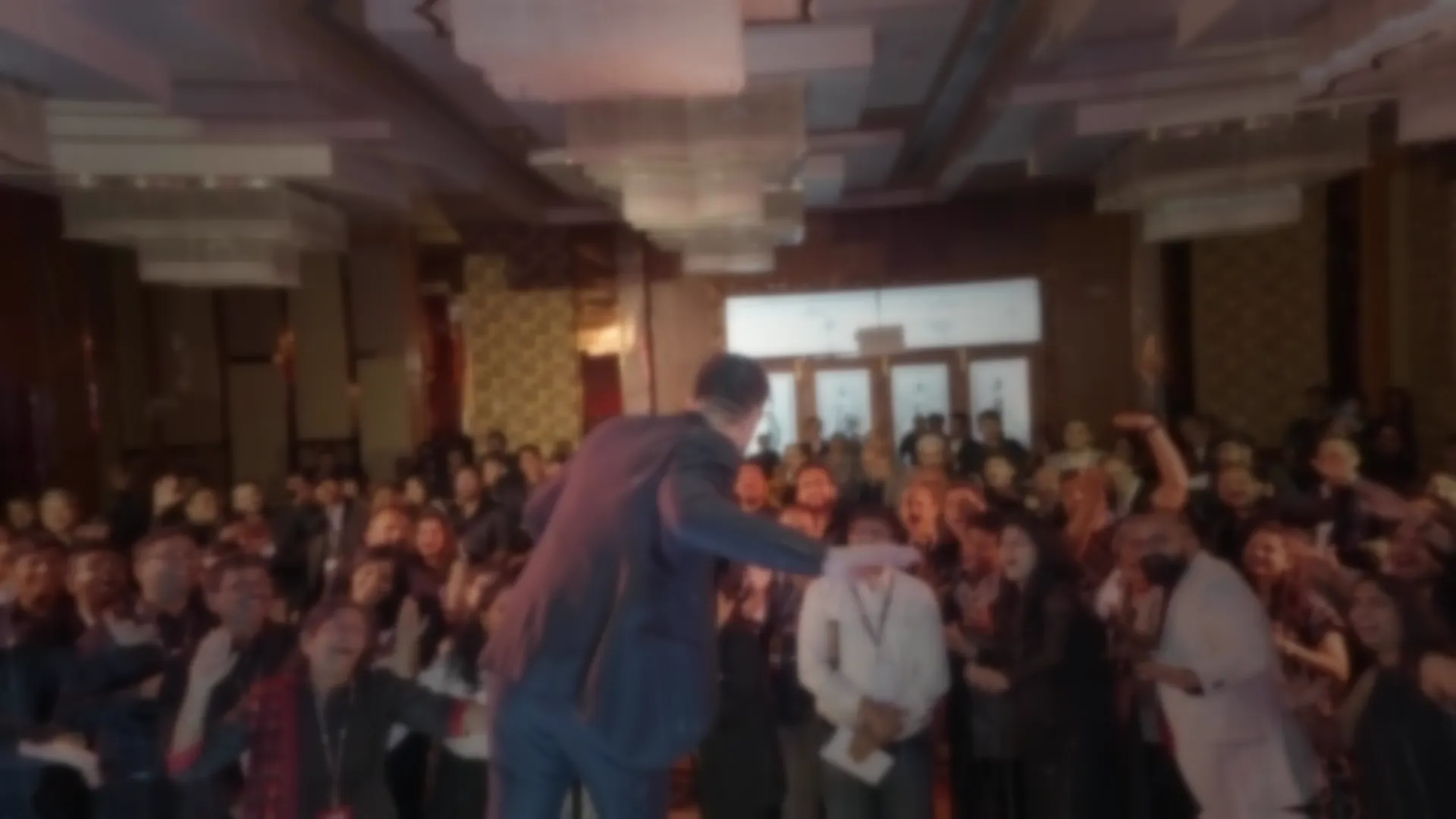 A packed ballroom on its feet during a Swastik Nandakumar live event.